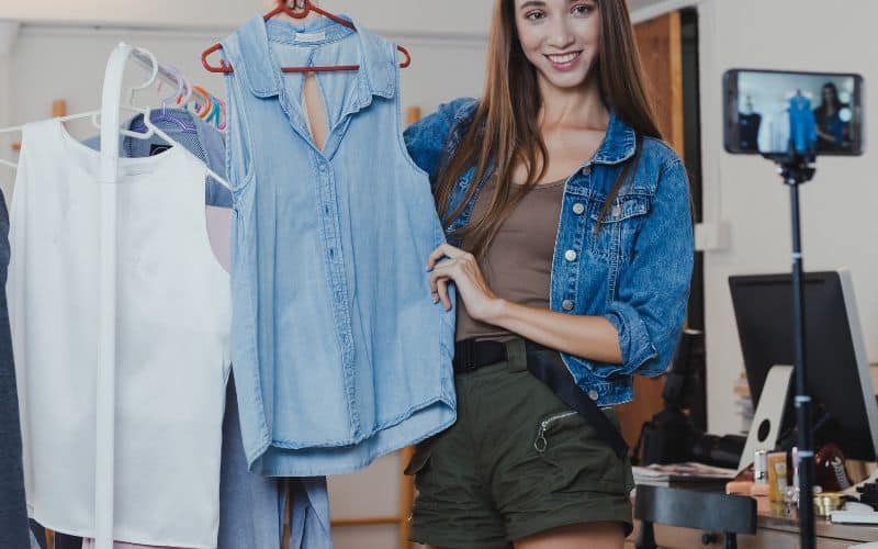 Woman showing off a clothes she is selling online