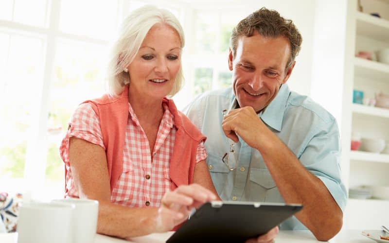 Photo showing a couple looking at the tablet