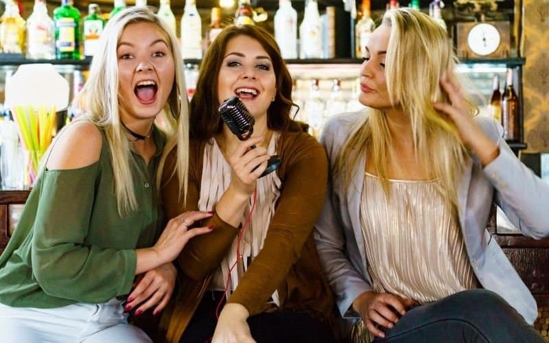 3 women singing while at home