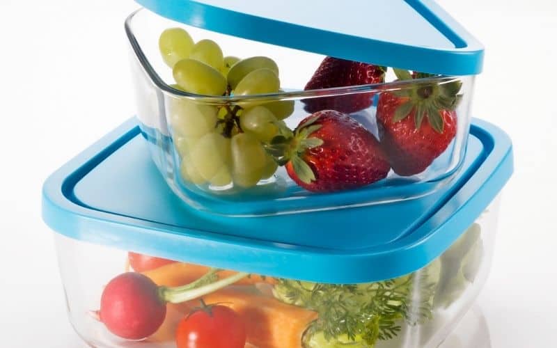 Photo of two glass containers with lid filled with different fruits.