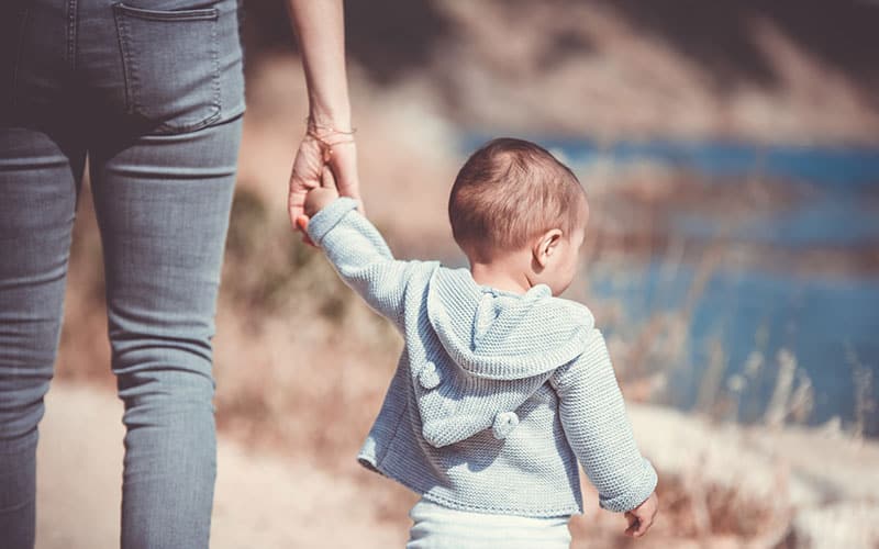 a person holding the baby's hand