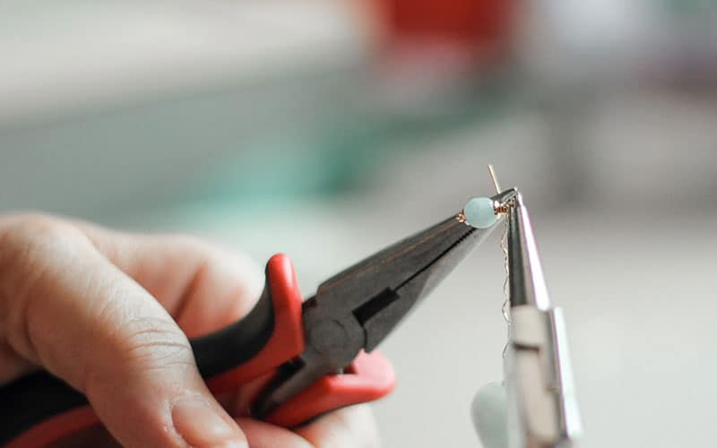 a person making hand jwellery 