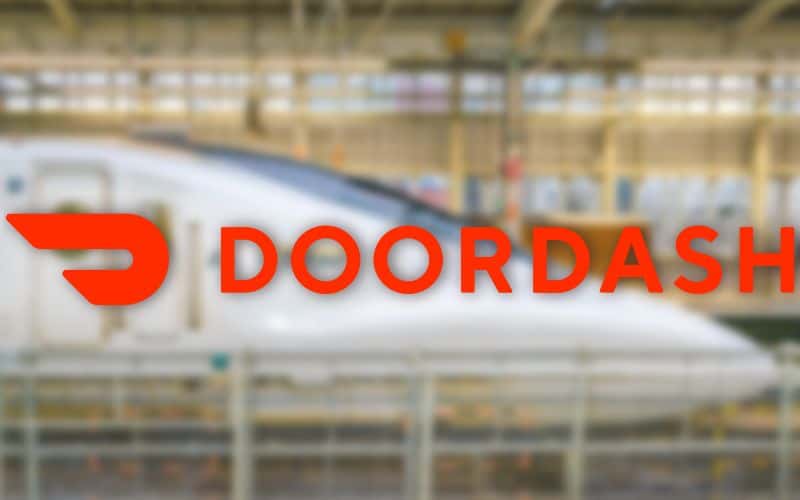 Text overlay of Doordash logo with blurred bullet train on background