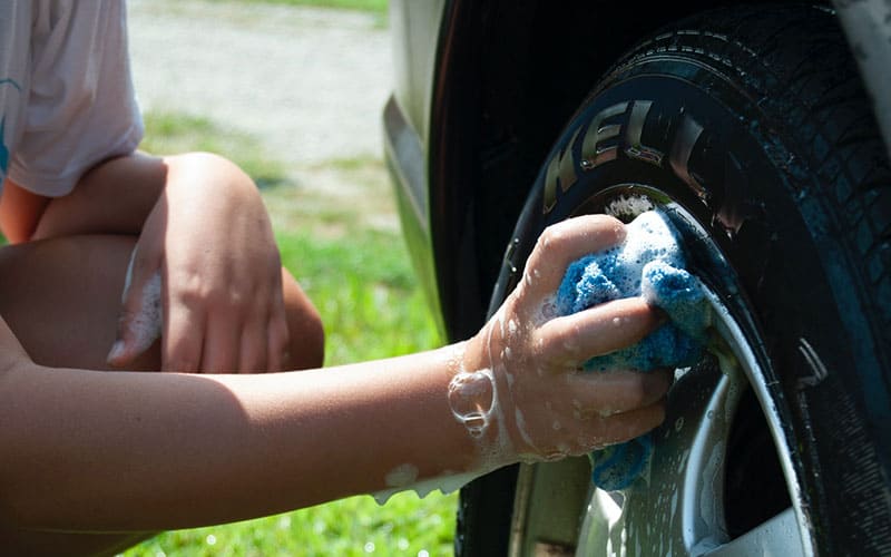 person washing the car with hands