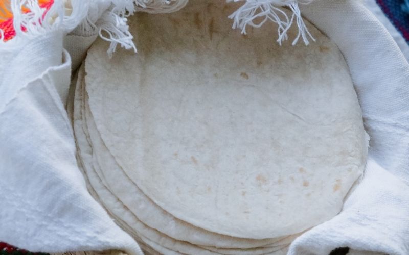 Photo of several pieces of tortillas in a white cloth