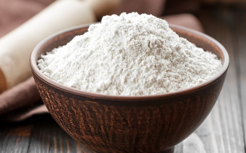 Photo of white flour in a brown bowl