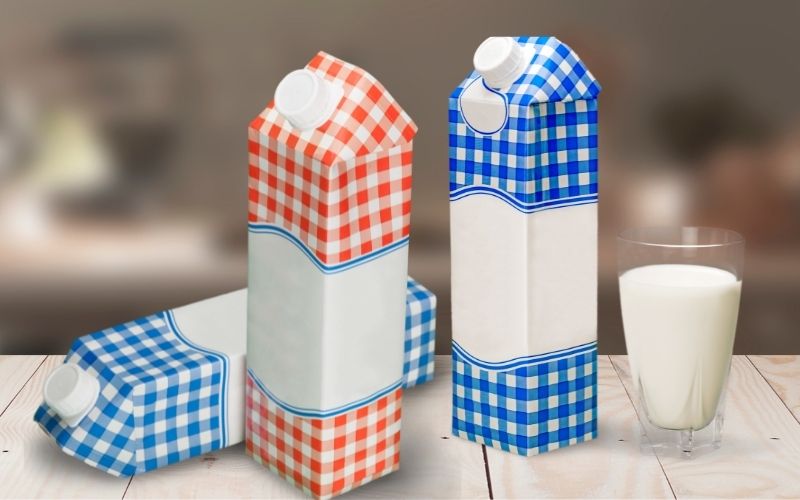 Photo of three shelf-stable milk and a glass of milk