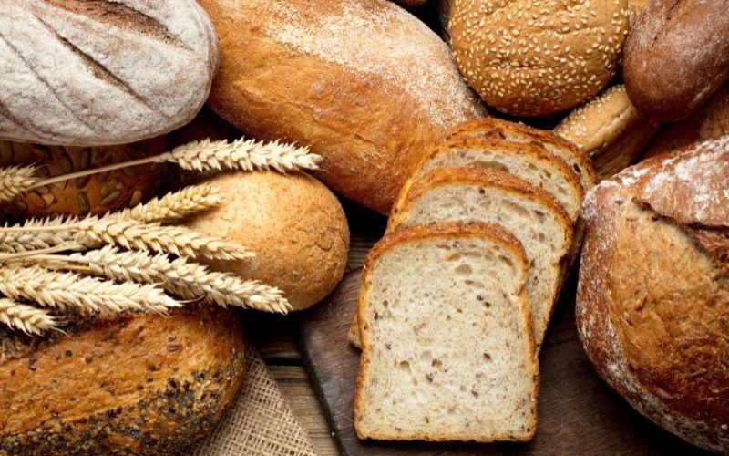 Photo of several kinds of whole and sliced breads