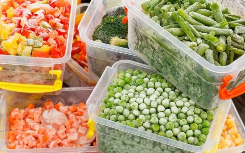 Photo of different frozen vegetables in plastic containers