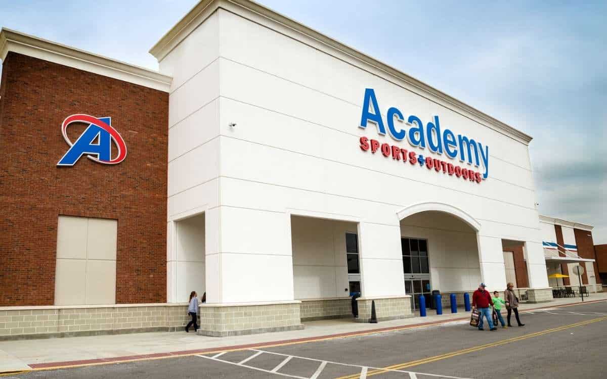 Photo of an off-white-colored building with the sign Academy sports above the main entrance