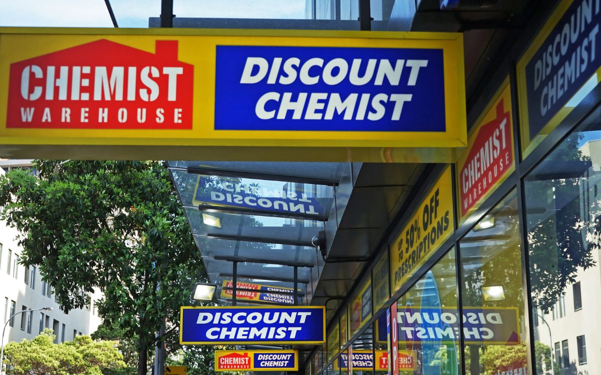 Image showing the entrance of a Pharmacy store with the name hanging board that reads Chemist Warehouse Discount Chemist