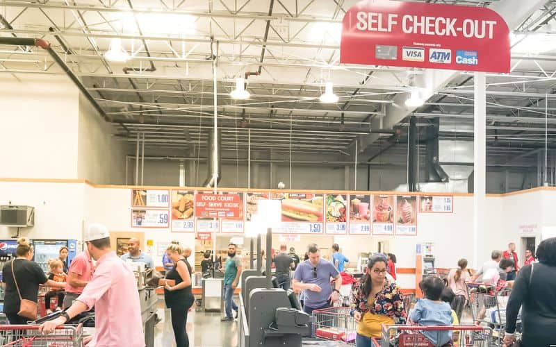 Inside Costco where people are paying in self check out area