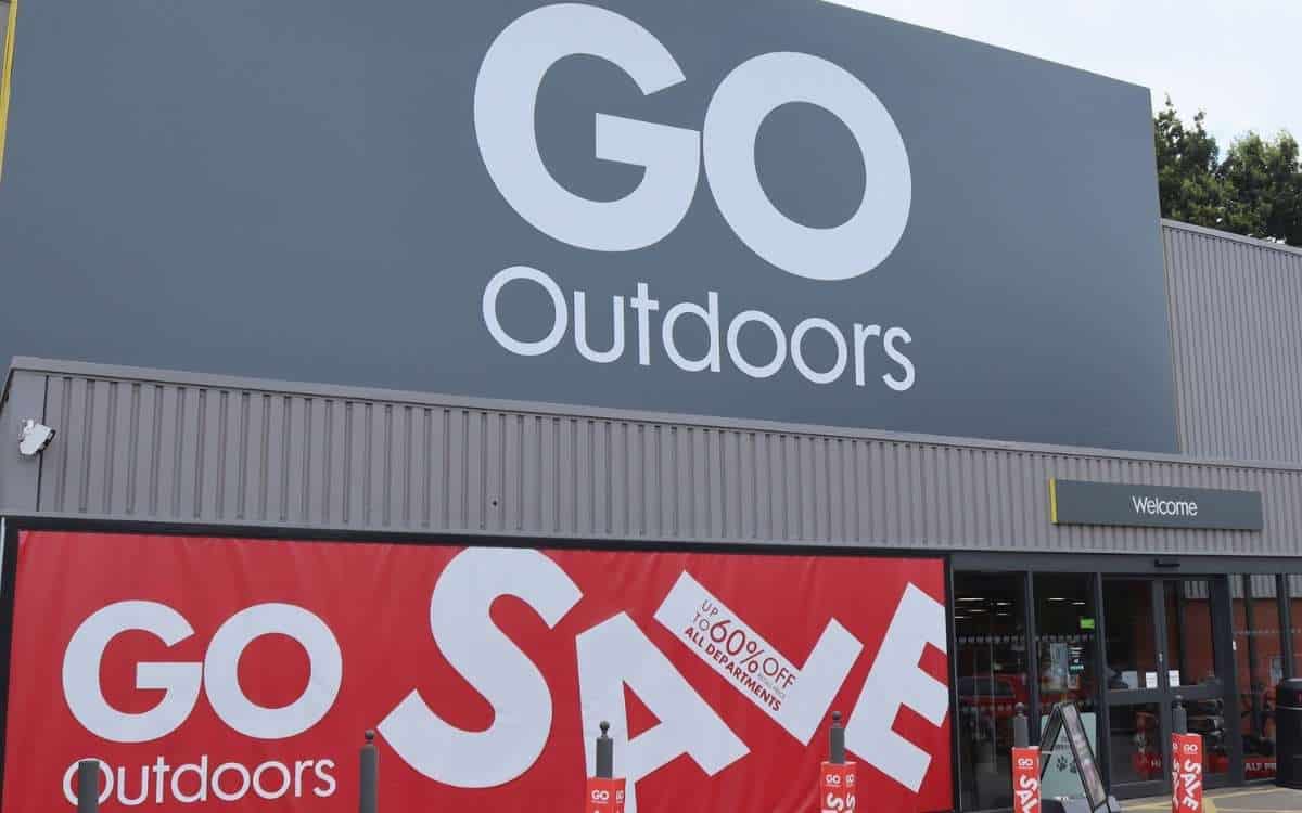 A large grey colored store with name GO Outdoors displayed above the entrance and a red banner with text that reads Go outdoors Sale.