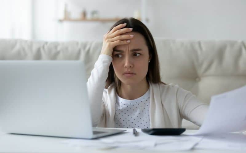 Image showing a person looking confused while staring at the laptop