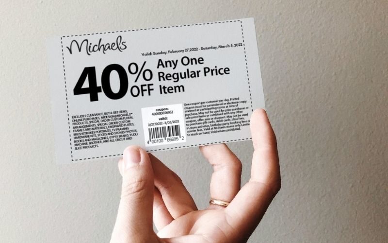 Photo of a hand holding a discount coupon from Micharl's