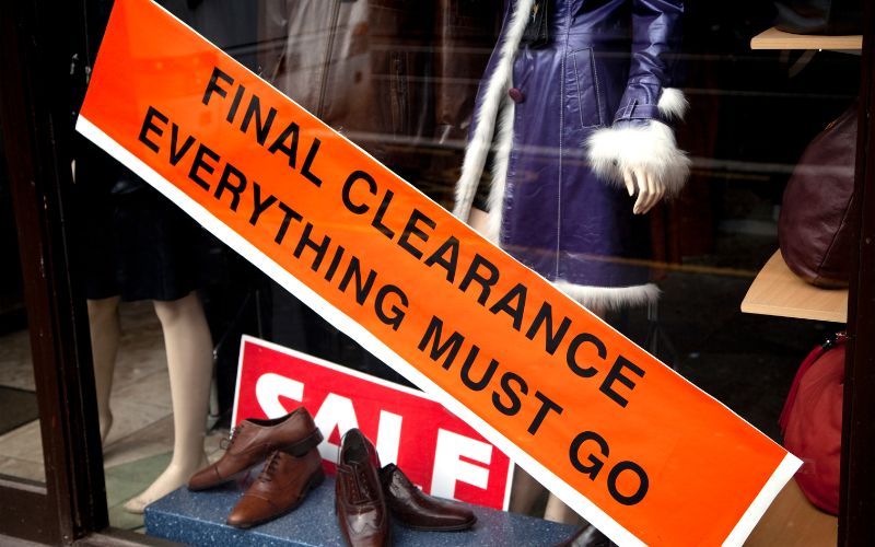 Image of a store of clothes with orange Final Clearance ad at the front