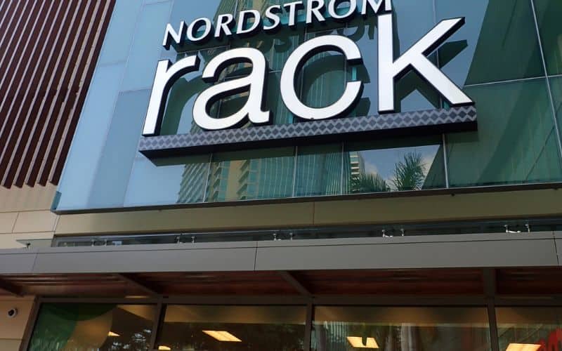 A large bluish grey building with Nordstrom rack i big letters placed over the main entrans