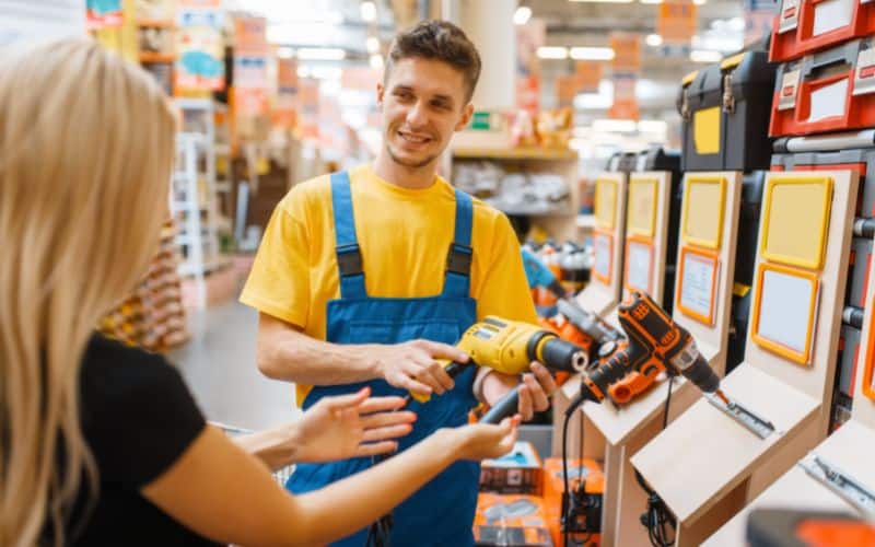 A man and a woman talking about the tool from a hardware store