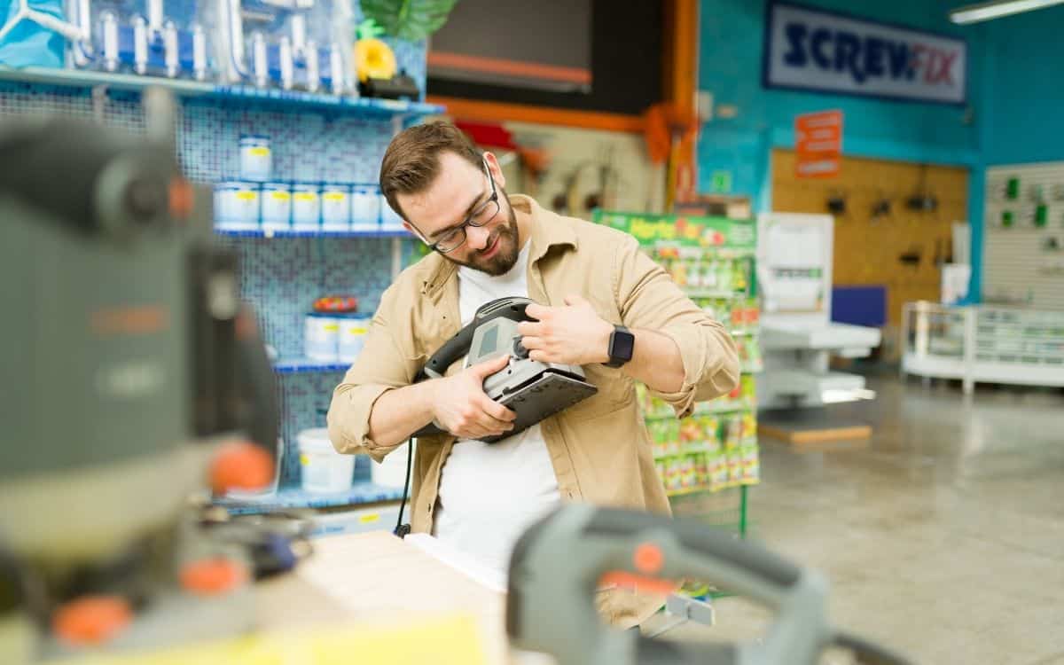 A man checking a tool from a store