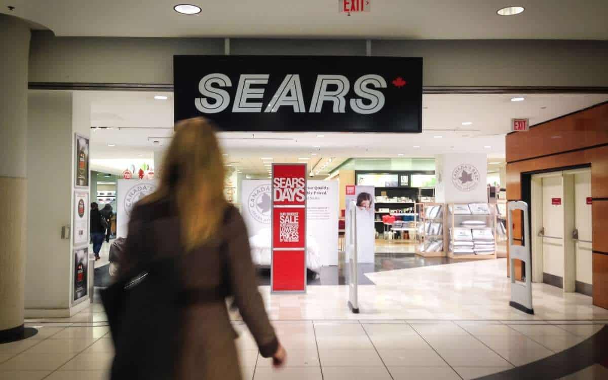 Photo of a woman walking towards a Sears store