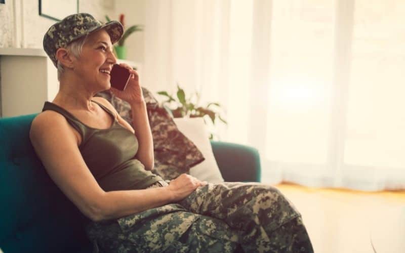 A US ilitary woman sitting and talking on her phone