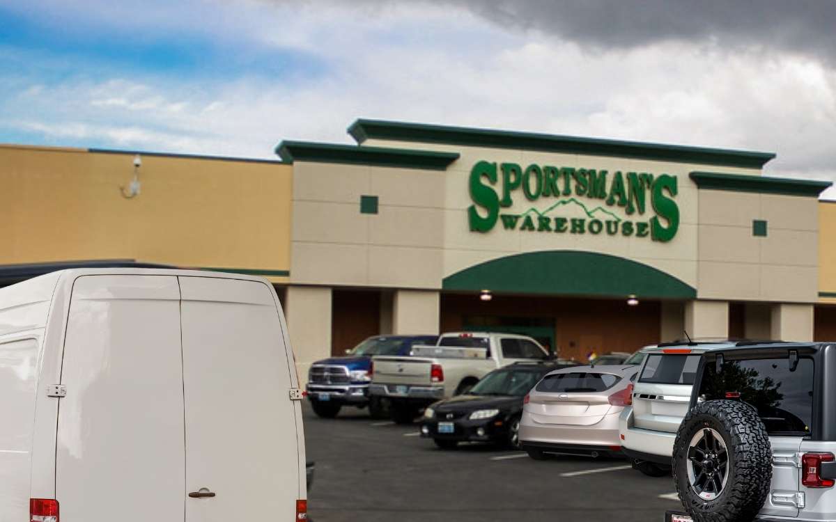 Parking area with cars in front of Sportsman's warehouse