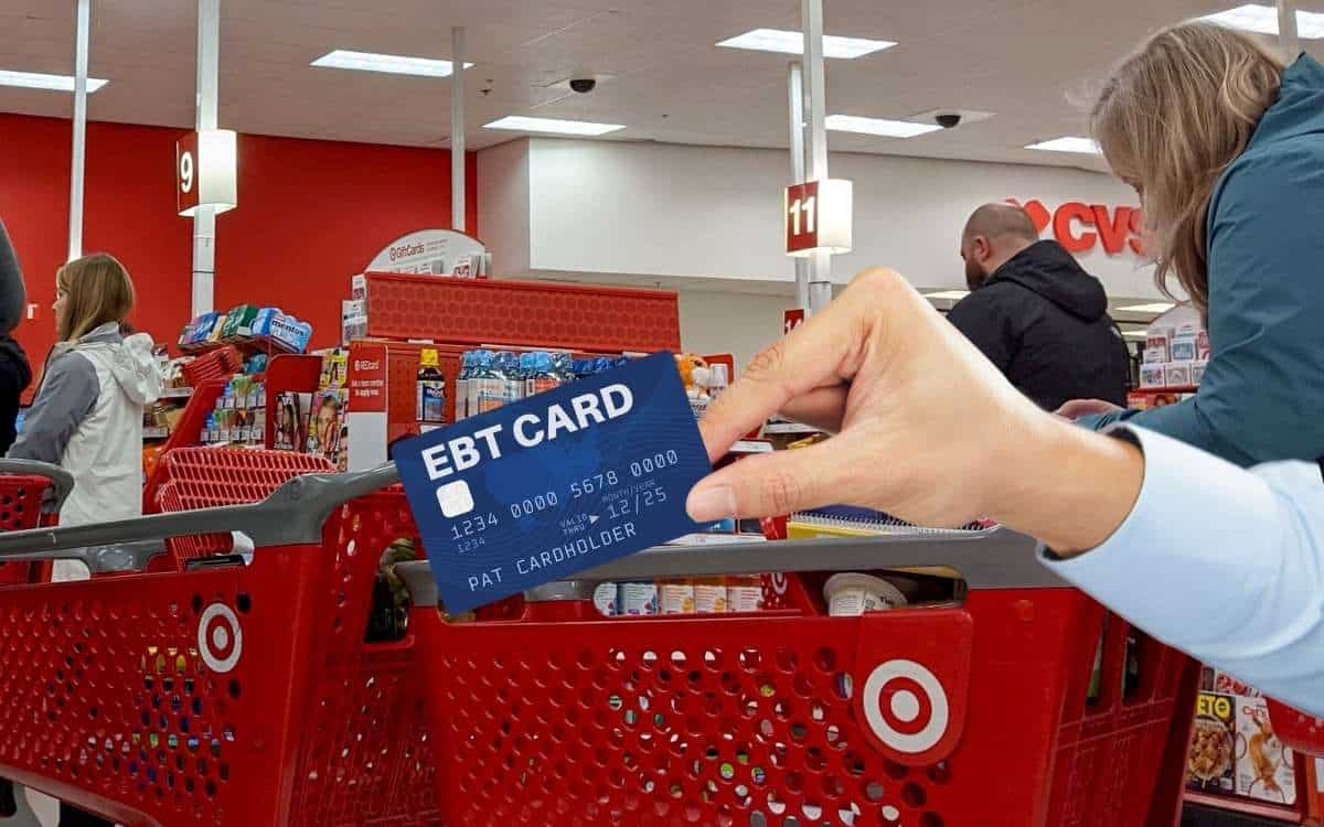 A hand holding a EBT card in a Target store