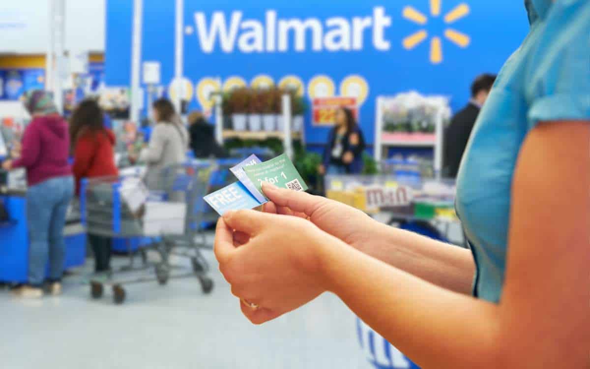 Woman holding coupons_Does Walmart Take Coupons Featured Image