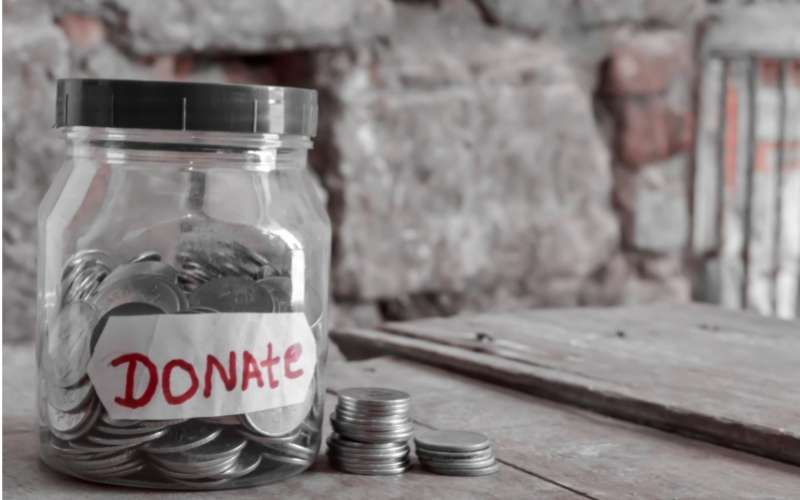 donate written jar on wooden table