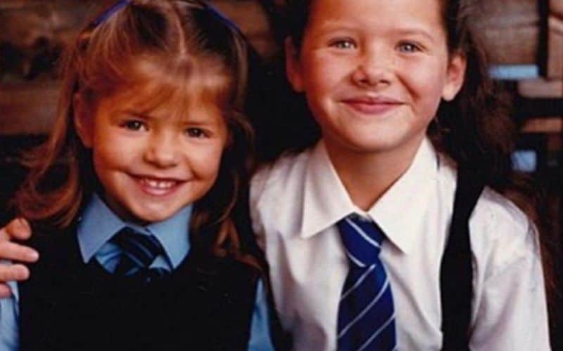 An old photo of two girls in their school uniforms smilling