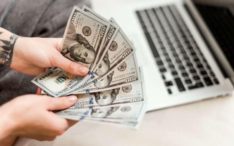 woman hands holding new dollars