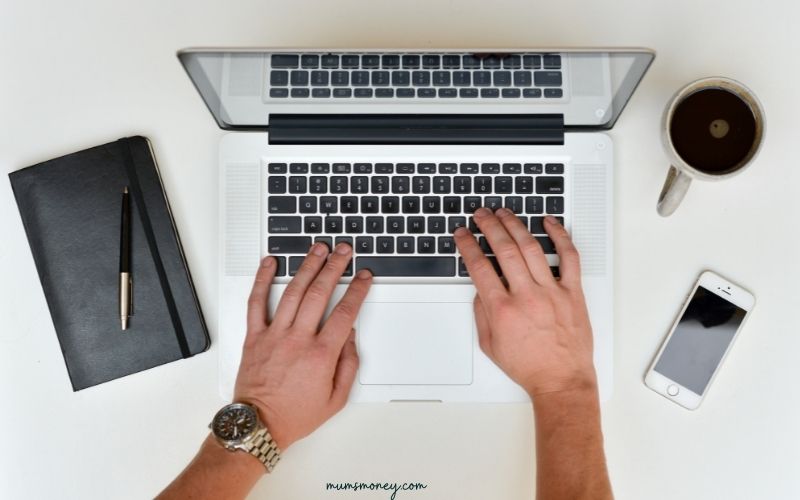 image of mans hands on laptop shot from above