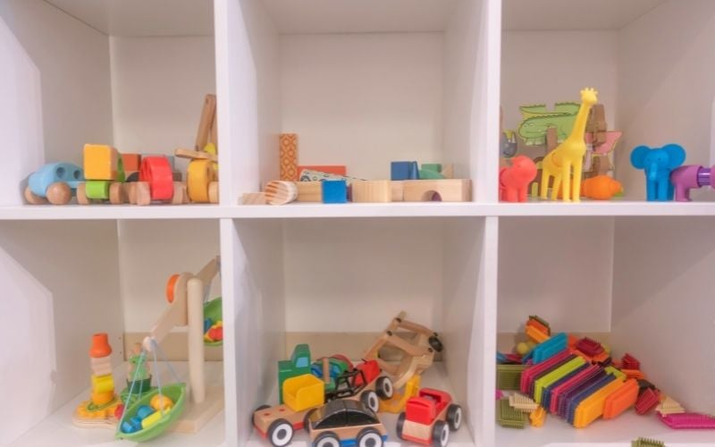 Phot of a shelves with different colorful toys