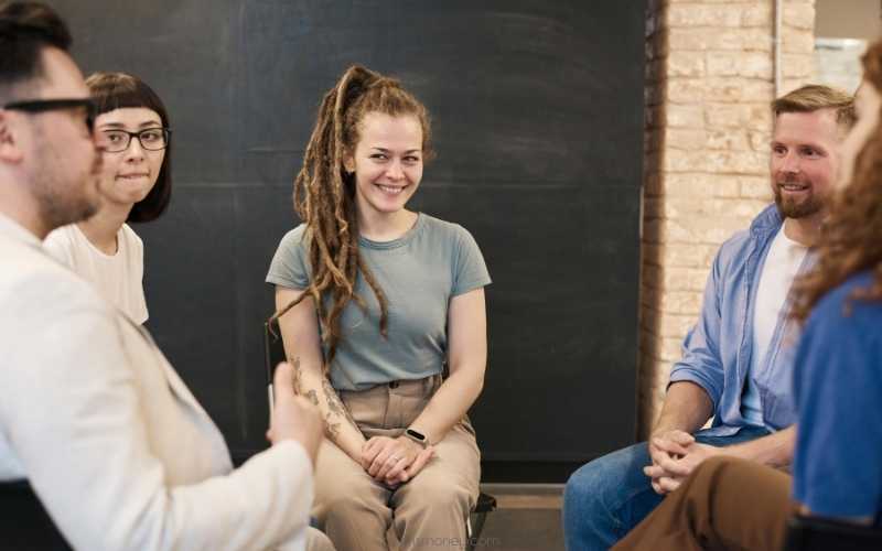 A group of people sitting and taking part in a focus group