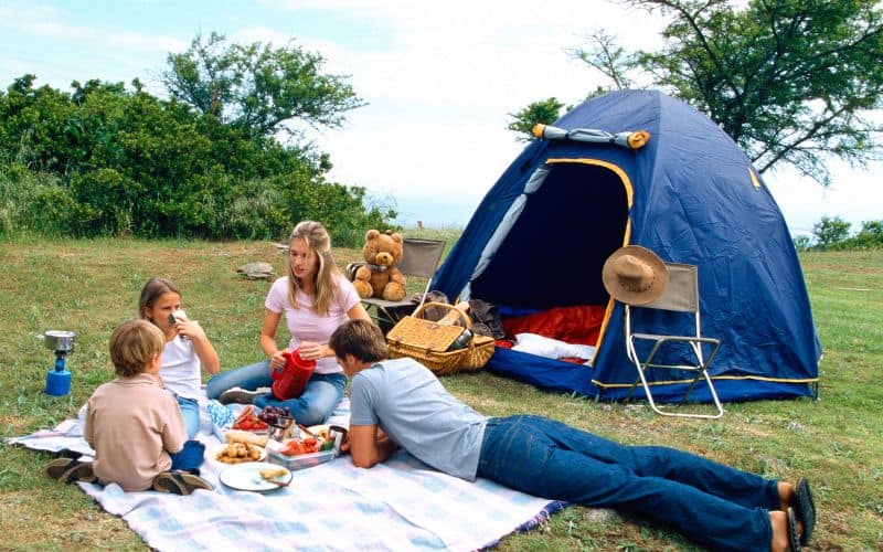 A Family camping in a park_Ways to Live a Rich Life on a Tiny Budget