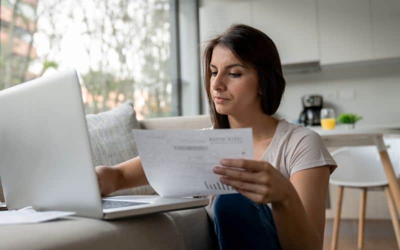 Woman checking the bills for payment_Ways to Live a Rich Life on a Tiny Budget