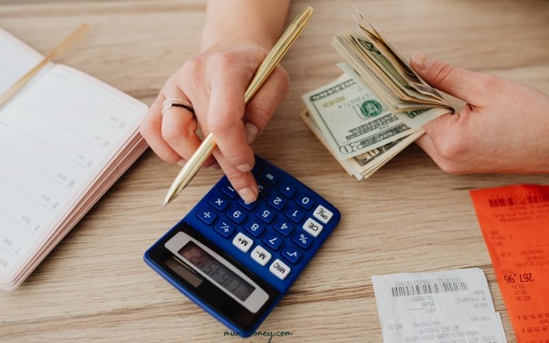 Person Holding Black Calculator and 100 Us Dollar Bill