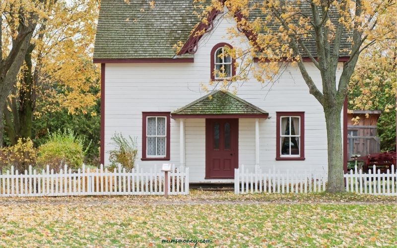 White and Red Wooden House With Fence