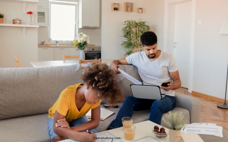 Father and Daughter Enjoying at Home. Little Girl Drawing While Father Working From Home