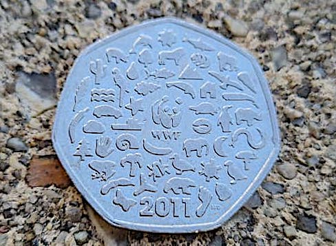 50p coin with WWF in centre and the year 2011 at the bottom. Lots of tiny animals in image.